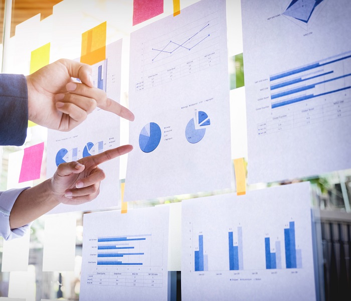 Businessman making presentation with his colleagues and business Businessman making presentation with his colleagues and business strategy digital layer effect at the office as concept.